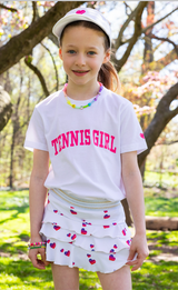 Girl wearing  Love Set Match white visor, white tennis girl t-shirt, and white ruffled love skirt with hearts on it from Love Set Match girls tennis wear.