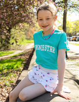 Girl wearing Love Set Match tennis star t-shirt in teal and white ruffled skirt with crowns on it