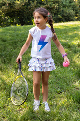 Young girl wearing a matching tennis set from Love Set Match tennis wear